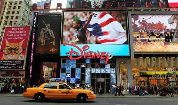 A taxi passes an Olympic display during the Team USA Road to London 100 Days Out Celebration in Times Square on April 18, 2012, in New York City